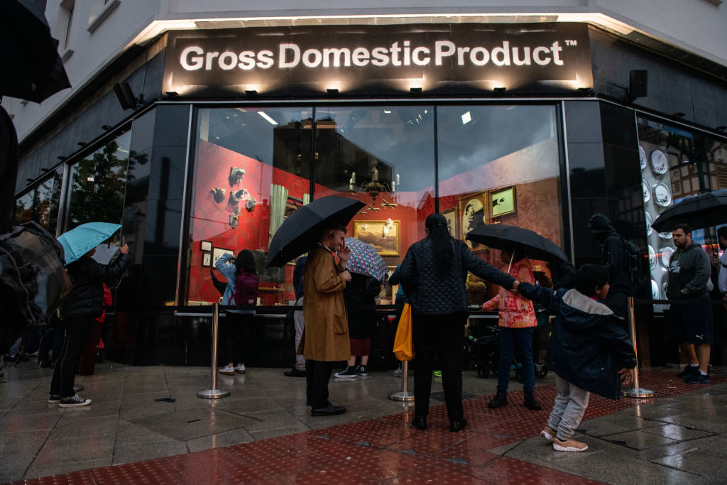 Members of the public queue to look at the new Gross Domestic Product installation by elusive artist Banksy on October 1, 2019 in Croydon, England, which the artist has said was created to thwart greeting-card company Full Colour Black from stealing his work. (Photo by Chris J Ratcliffe/Getty Images)