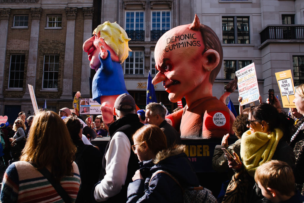 An effigy of British Prime Minister, Boris Johnson being used as a puppet by senior adviser Dominic Cummings being moved along St James's Street during the protest organised by the 'People's Vote' campaign for a second Brexit referendum. Photo by David Cliff/SOPA Images/LightRocket via Getty Images.
