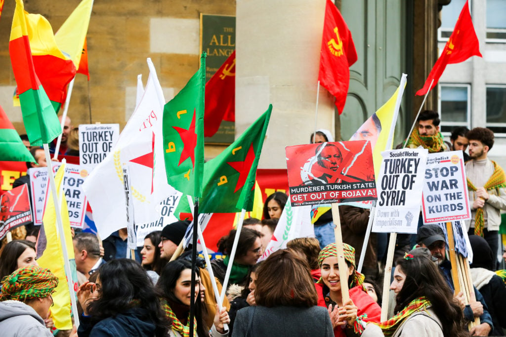 Kurdish protesters with placards and flags during a demonstration in London. Photo: Steve Taylor/SOPA Images/LightRocket via Getty Images.