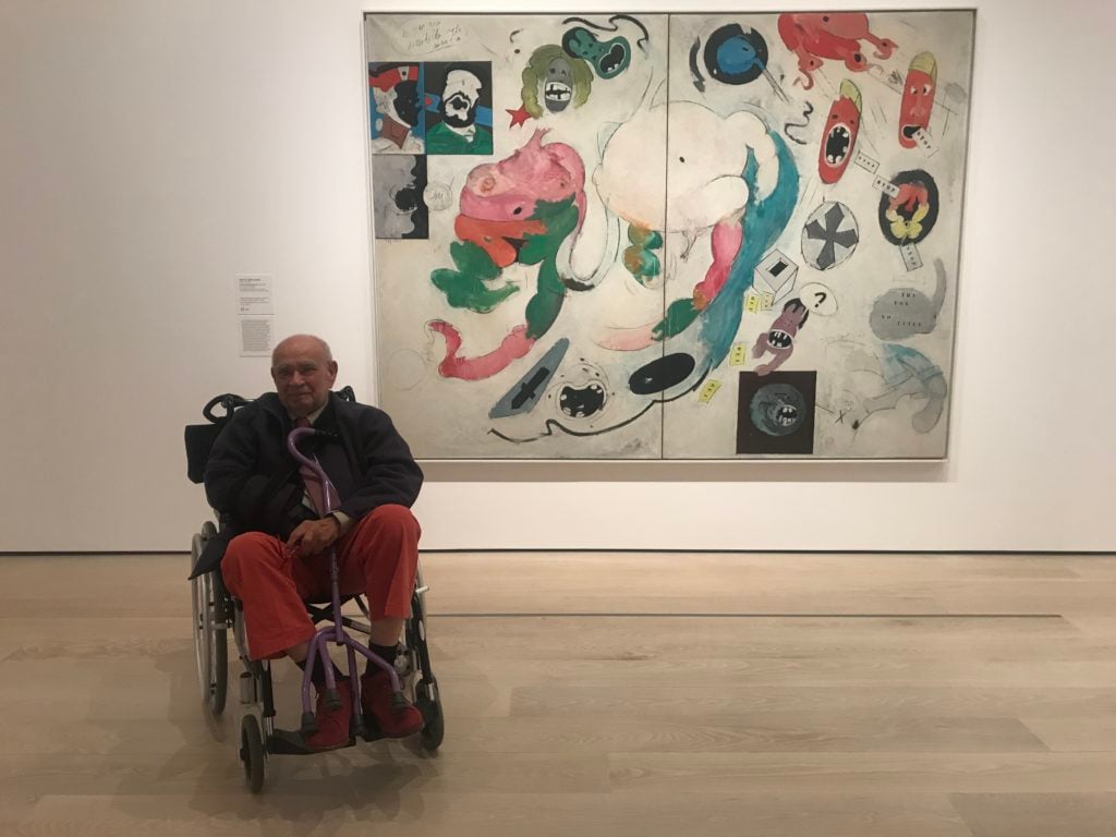 Télémaque with his painting No Title (The Ugly American) at the Museum of Modern Art (2019). Courtesy of the artist. 