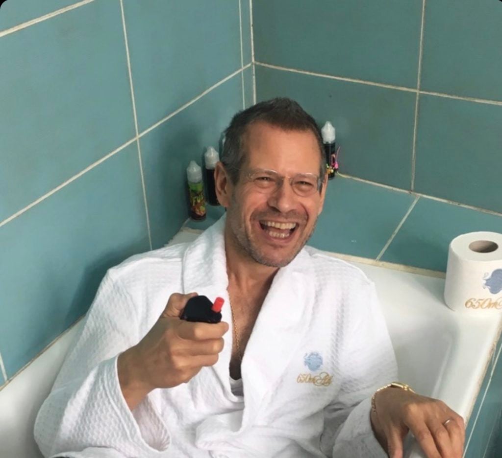 My Hugh Hefner impersonation. Unwinding in the vape lounge of 650mAh projects space at Paris Internationale. Photo courtesy of Kenny Schachter.