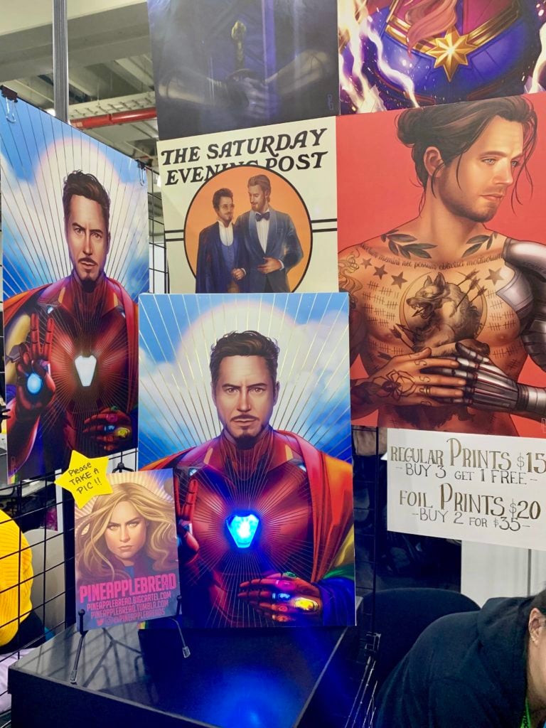 Pineapple Bread's Artist Alley booth at New York Comic Con includes fan art embracing a romantic relationship between Iron Man and Captain American inspired by the <em>Saturday Evening Post</em> covers of J.C. Leyendecker. Photo by Sarah Cascone. 