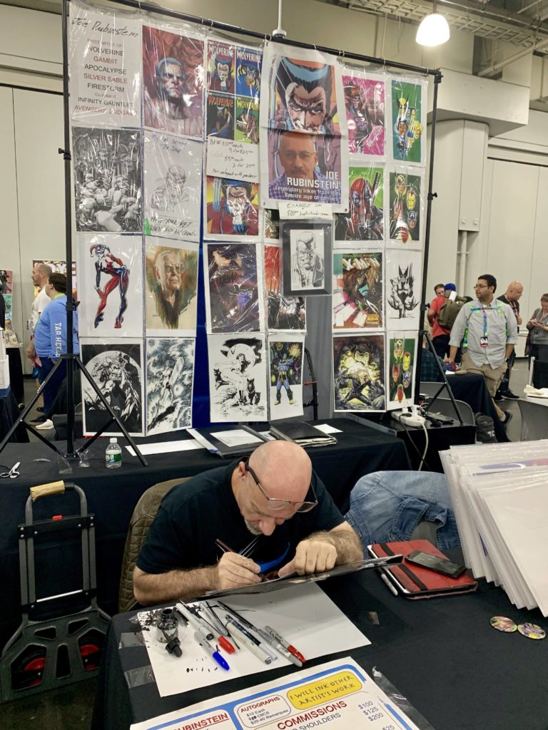 Joe Rubinstein draws at his Artist Alley booth at New York Comic Con. Photo by Sarah Cascone. 