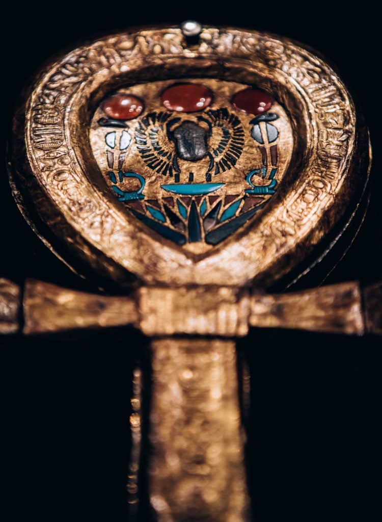 Wooden Gilded Mirror Case in Form of an Ankh, Inlaid with Blue Glass and Carnelian. Image courtesy IMG.