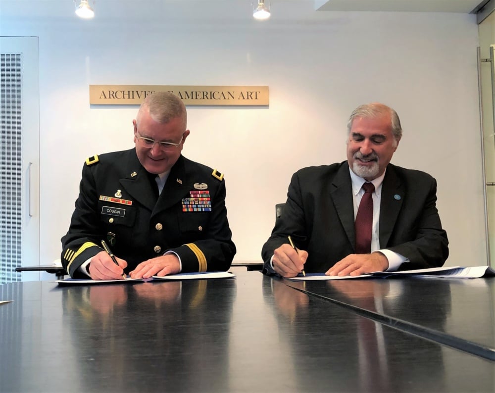 Brigadier general Jeffrey C. Coggin, deputy commanding general of US Army Civil Affairs and Psychological Operations Command (Airborne) and Richard Kurin, Smithsonian distinguished scholar and ambassador-at-large sign an agreement to train and support US military personnel working to protect cultural property during armed conflict. U.S. Army Reserve photo by Lt. Col. Jefferson Wolfe, USACAPOC public affairs officer.