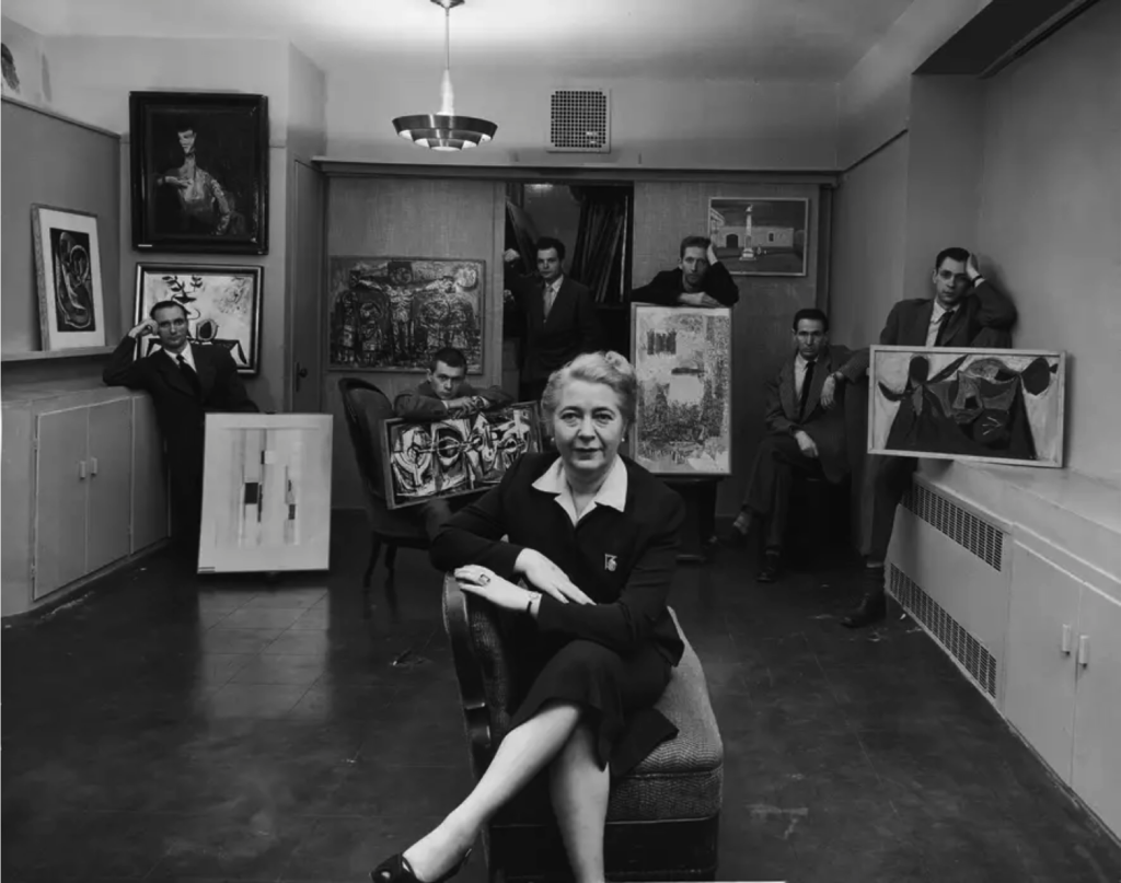 Edith Halpert at the Downtown Gallery, surrounded by some of her artists, in a photograph for Life magazine in 1952. Photograph © Estate of Louis Faurer