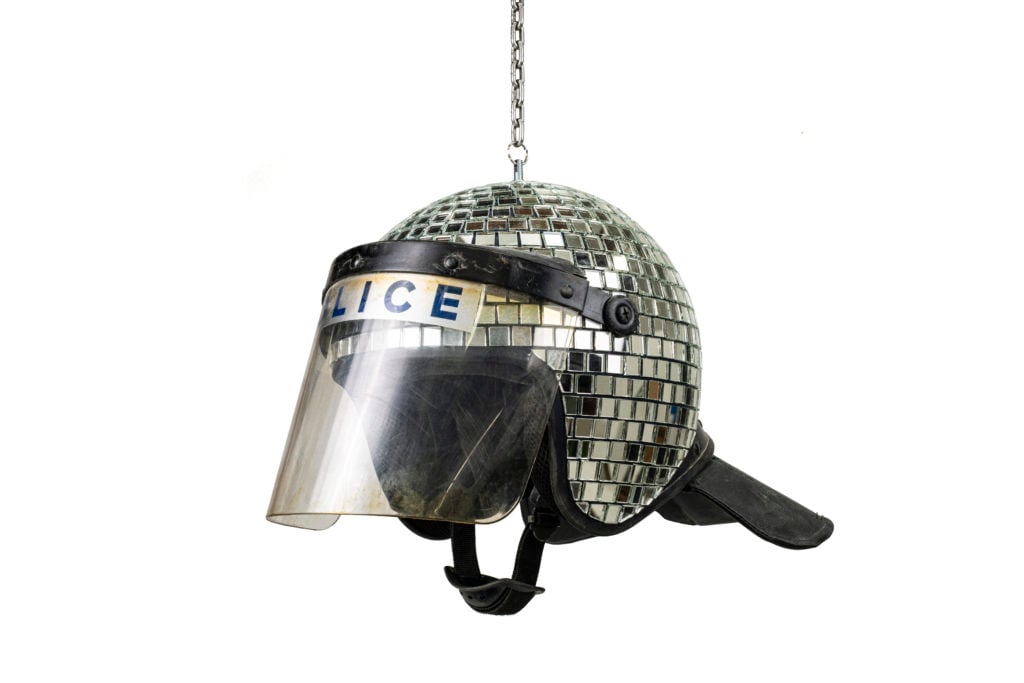 A police riot helmet disco ball is one of the goods available from Banksy's new shop Gross Domestic Product. Photo courtesy of the artist. 