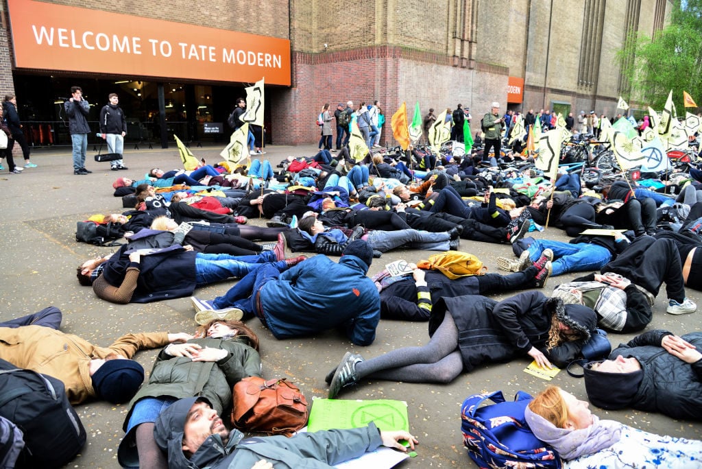 Activists from Extinction Rebellion stage a die in demonstration at Tate Modern. Photo by Claire Doherty/In Pictures via Getty Images Images.