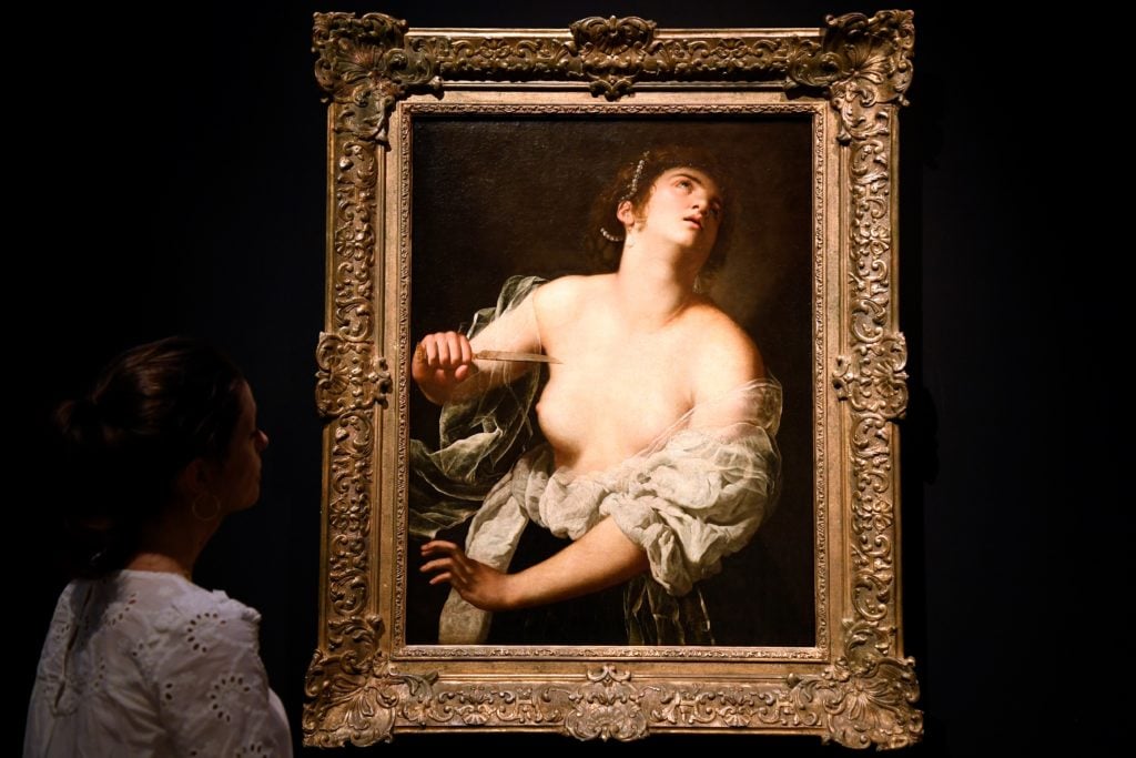 A woman looks at the painting 'Lucrece' by female Italian Baroque painter Artemisia Gentileschi (1593 to ab 1652),. (Photo by BERTRAND GUAY/AFP via Getty Images)