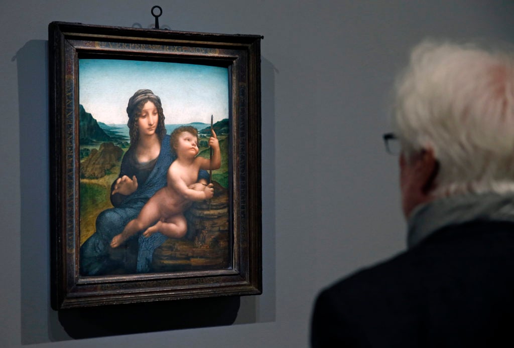 A visitor taking in one of Leonardo's works at the Louvre. (Photo by Chesnot/Getty Images)