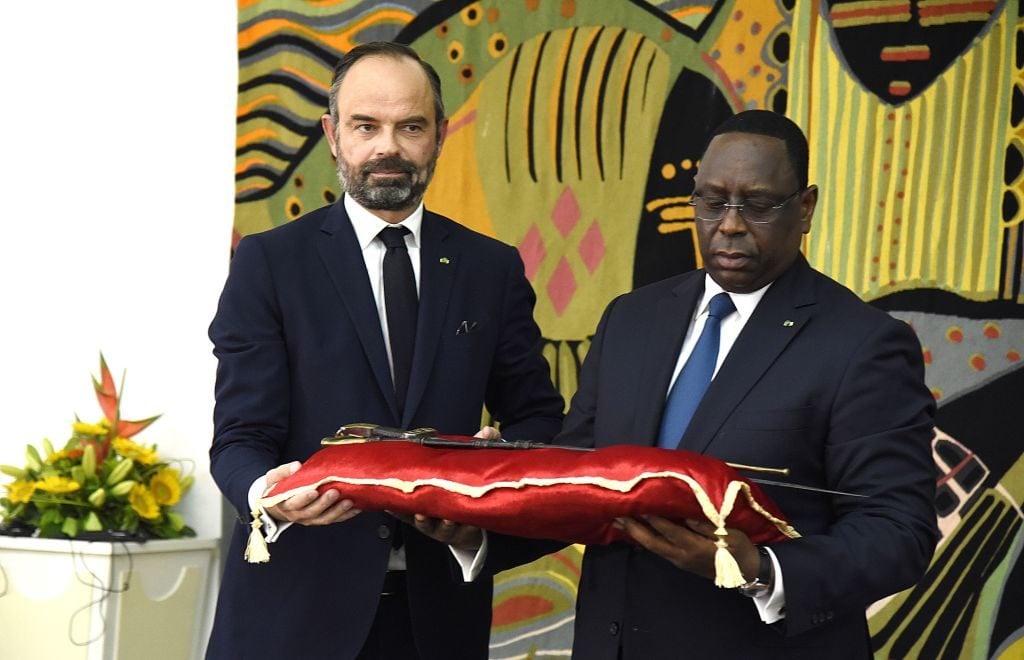 Senegal's President, Macky Sall, receives the sword of Omar Tall from French Prime Minister Edouard Philippe at the Palace of the Republic in Dakar, Senegal, on Novamber 17, 2019. Photo by Seyllou/AFP /AFP via Getty Images.