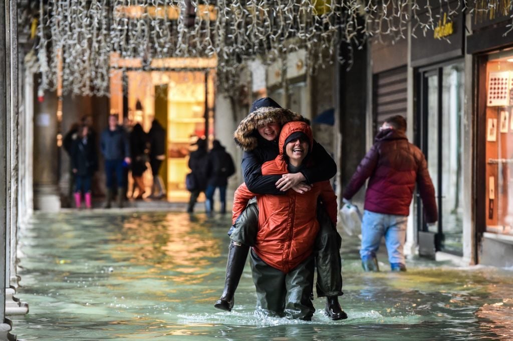 Fun in a flooded Venetian arcade on November 24, 2019. (Photo by Miguel MEDINA / AFP) (Photo by MIGUEL MEDINA/AFP via Getty Images)