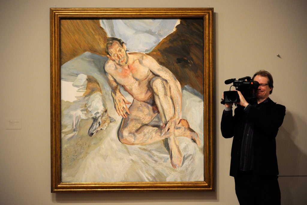 A cameraman films beside the unfinished painting entitled 'Portrait of The Hound, 2011' by British artist Lucian Freud at the National Portrait Gallery in London, on February 8, 2012. Photo: CARL COURT/AFP via Getty Images.