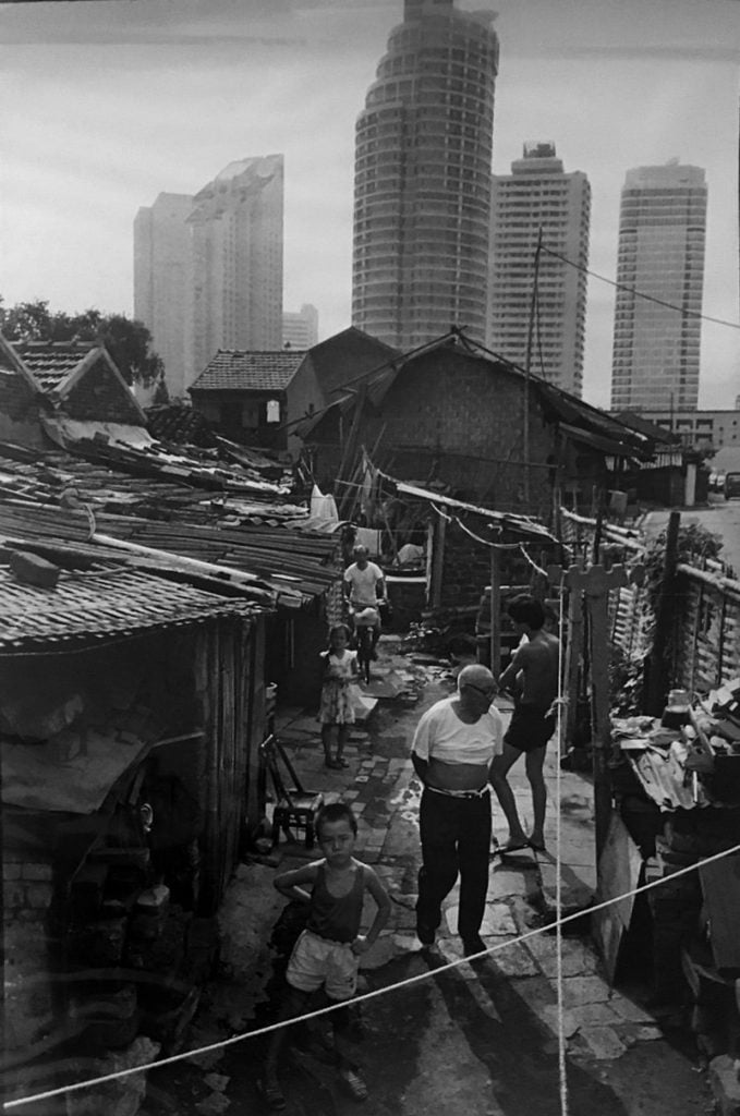 Marc Riboud, These people’s houses have been destroyed to make way for new tower blocks. Waiting to be rehoused, they live in shanty towns. Shanghai (1992). Courtesy of Galerija Fotografija.