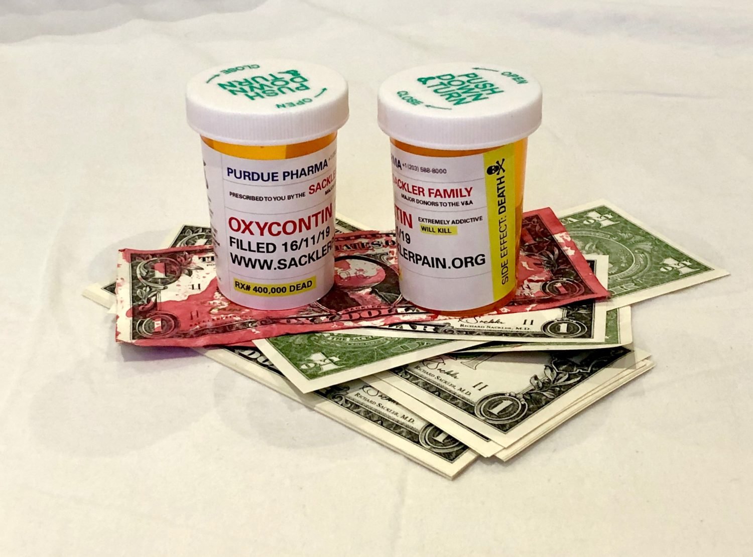 Sackler PAIN's customized Rx bottles and photoedited "blood money." Courtesy Sackler PAIN.