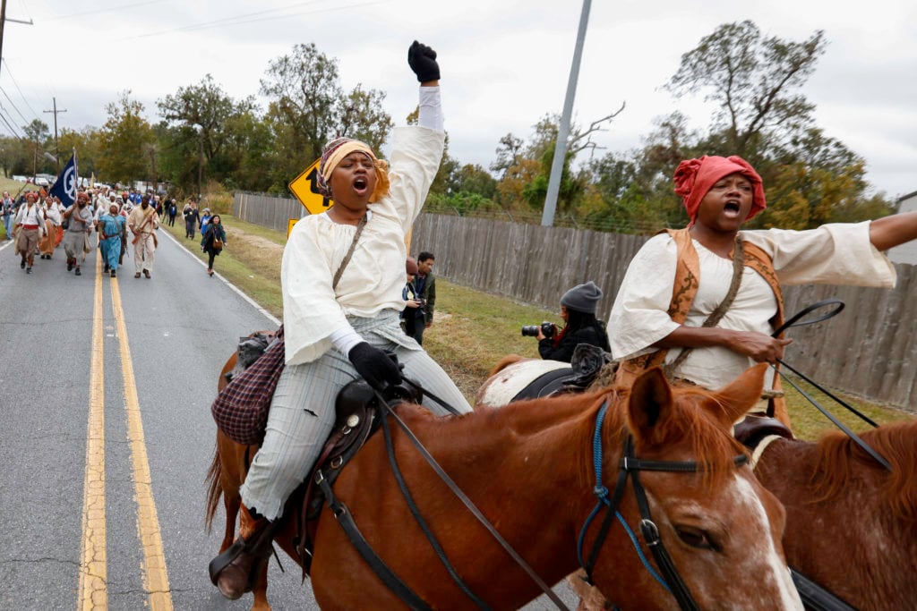 Reenactors marching across the 26-mile path through Louisiana. Costumes designed by Alison Parker, Photo: Soul Brother. Courtesy of SRR.