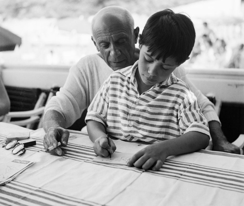 Pablo Picasso with his son Claude, August 21, 1955. Image courtesy Getty Images.
