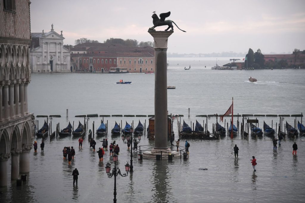 A general view shows the Doge's Palace overlooking the flooded St. Mark's Square, the Lion of St. Mark winged bronze statue [center], gondolas and the Venetian lagoon during the floods on November 13 in Venice. Photo by Marco Bertorello/AFP via Getty Images.