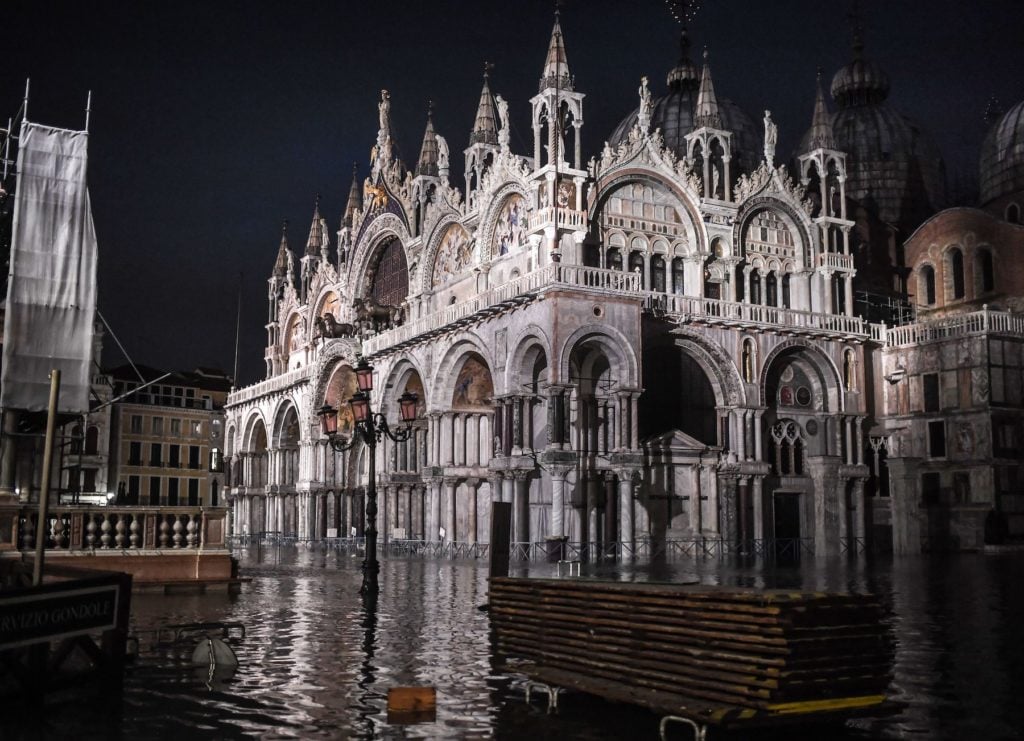 The flooded Piazza San Marco, with the San Marco Basilica, pictured during the flooding in Venice on November 12, 2019. Photo by Marco Bertorello/AFP via Getty Images.