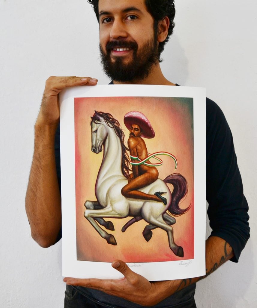 Fabian Chairez with a limited edition print of his controversial painting La Revolución, depicting famed Mexican revolutionary Emilio Zapata. Photo courtesy of the artist.