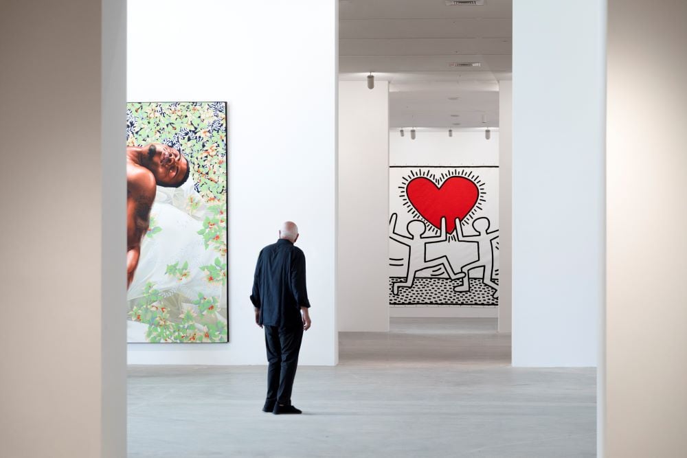 Don Rubell in front of work by Kehinde Wiley and Keith Haring at the Rubell Museum. Image courtesy of the Rubell Museum.
