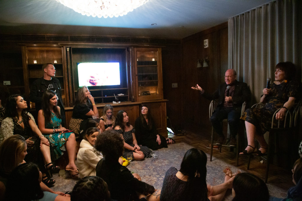 Jerry Saltz and Marilyn Minter talk to an intimate crowd about art and sex at Playboy's Art Basel Miami Beach dinner. Photo by Tiffany Sage, courtesy of BFA. 