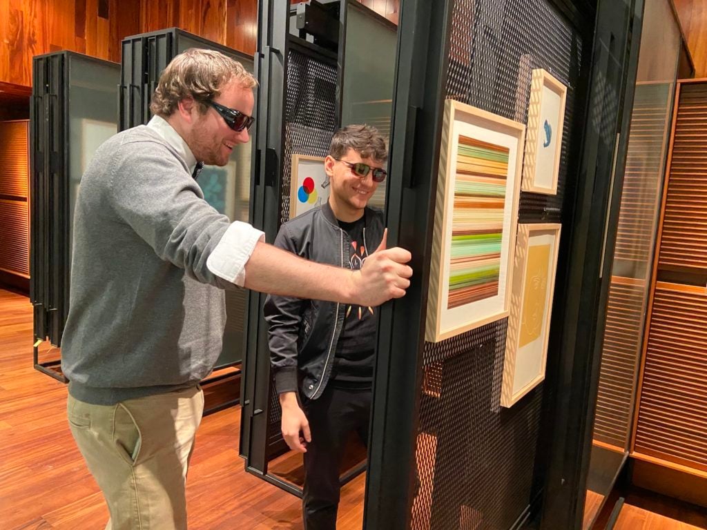 Colorblind people try on EnChroma's glasses that correct for colorblindness. Courtesy MCA Denver.