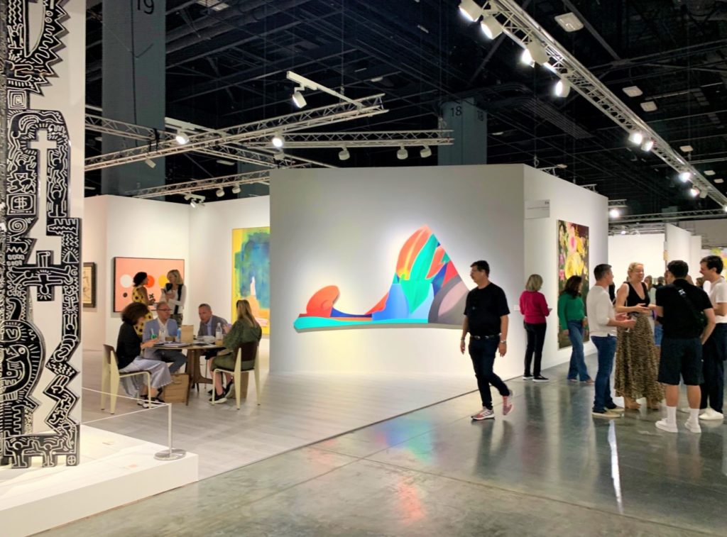 The action on the floor and in the booth of Edward Tyler Nahem during the VIP preview for Art Basel Miami Beach 2019. Image: Eileen Kinsella.