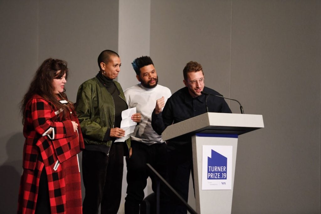 Tai Shani, Helen Cammock, Oscar Murillo and Lawrence Abu Hamdan celebrate after being announced as the joint winners of Turner Prize 2019 by Edward Enninful, Editor-in-Chief of British Vogue in Margate. Photo by Stuart C. Wilson/Stuart Wilson/Getty Images for Turner Contemporary.