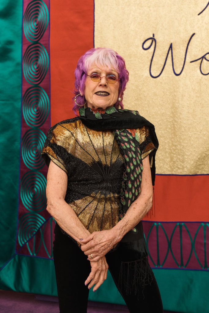 Judy Chicago beside one of her banners at the Dior show on Monday. Photo courtesy Christian Dior.