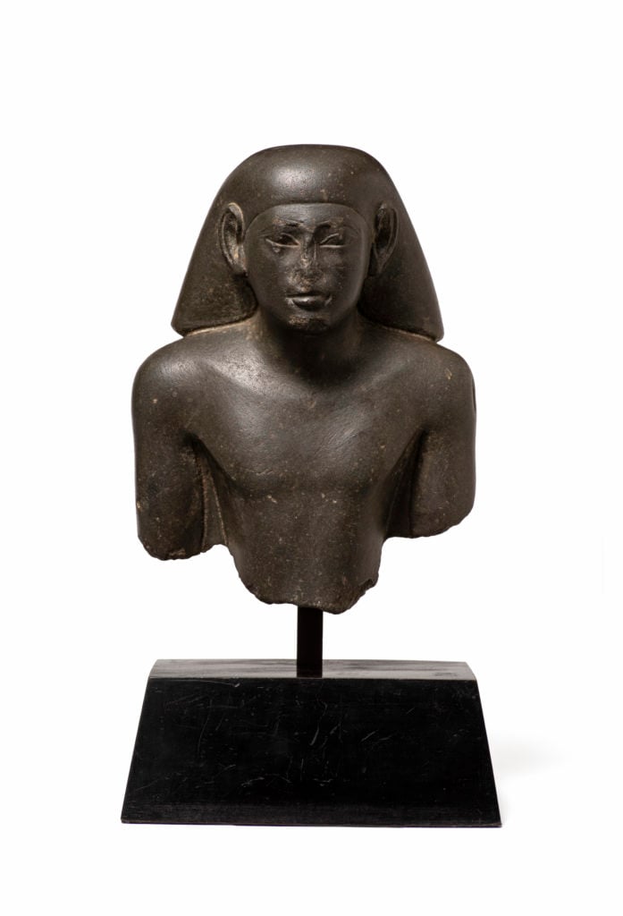 Egyptian green basalt bust of a seated nobleman or scribe, Late Dynastic Period, early 26th Dynasty, reign of Psamtik I, c. 664-610 BC. Courtesy of Charles Ede.
