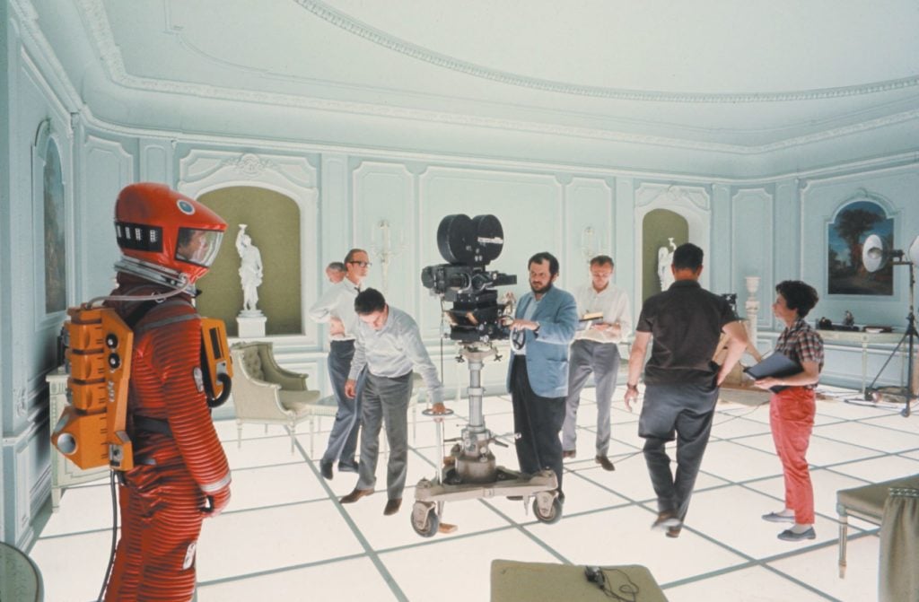 On the Hotel Room set of 2001: A Space Odyssey (1968, Dir. Stanley Kubrick). Kubrick is shown at center behind the camera. Courtesy of Warner Bros.