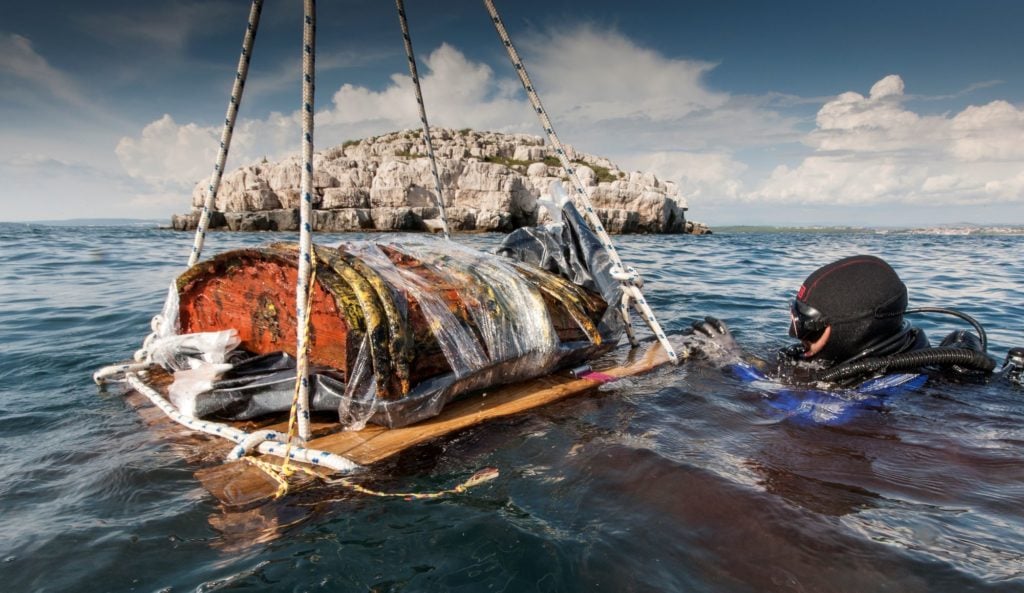 An archaeologist uncovers part of the cargo of a16th-century Venetian shipwreck. Image courtesy of the department of archaeology, University of Zadar.