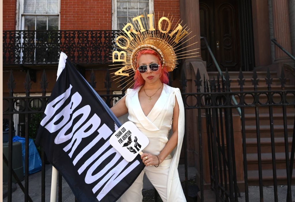 Viva Ruiz from "Thank God For Abortion" poses for a photo as she takes part in an abortion rights rally in front of the Middle Collegiate Church in the East Village of New York on May 21, 2019. Photo by Timothy A. Clary/AFP/Getty Images.