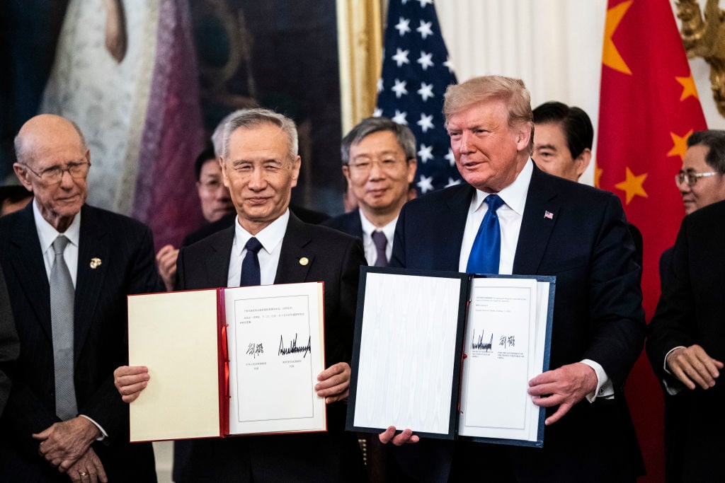 President Donald Trump signs a trade agreement with Chinese Vice Premier Liu He in the East Room at the White House. Photo: Jabin Botsford/The Washington Post via Getty Images.