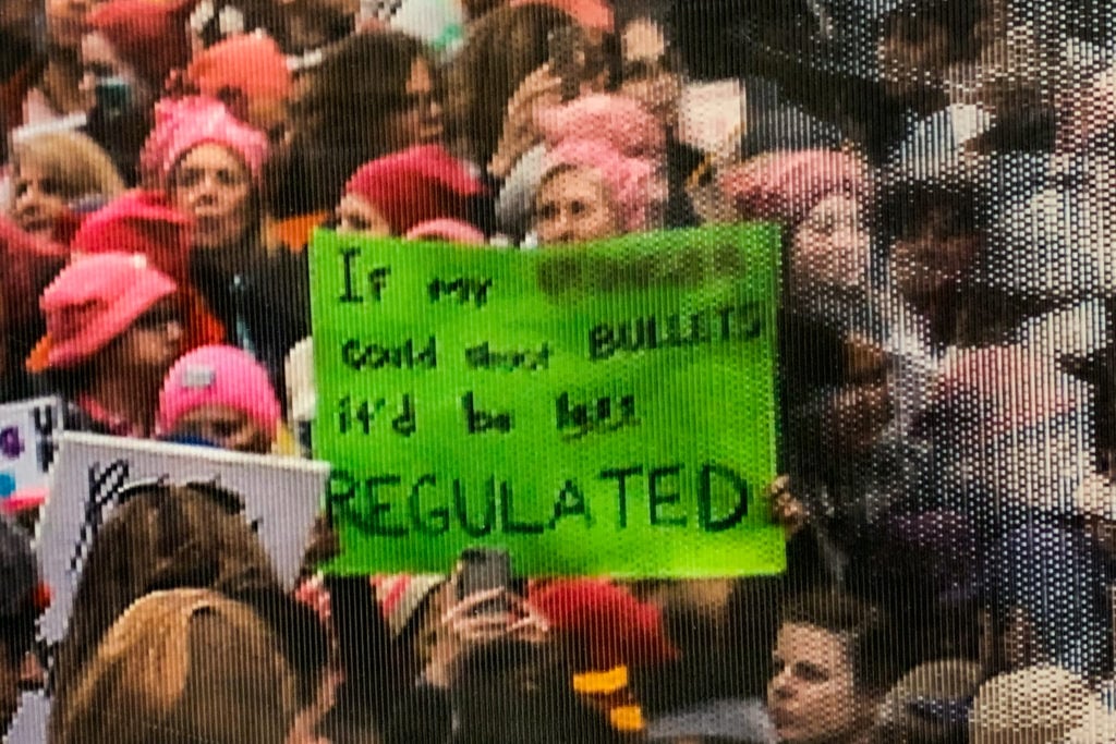A close up on the altered sign in the photograph from Women's March in 2017. The original sign read "If my pussy could shoot bullets it'd be regulated," here "pussy" is blurred out. (Photo by Salwan Georges/The Washington Post via Getty Images)
