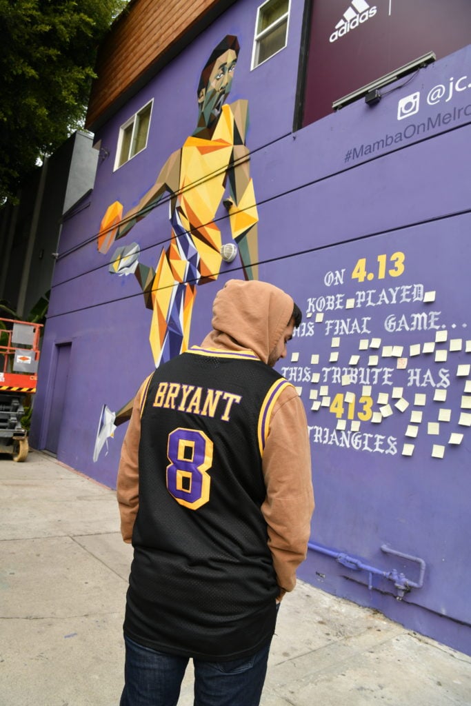A fan is seen at a memorial started next to a mural of Kobe Bryant by JC Ro on Melrose Avenue on January 26, 2020 in Los Angeles, California. Photo by Rodin Eckenroth/Getty Images.