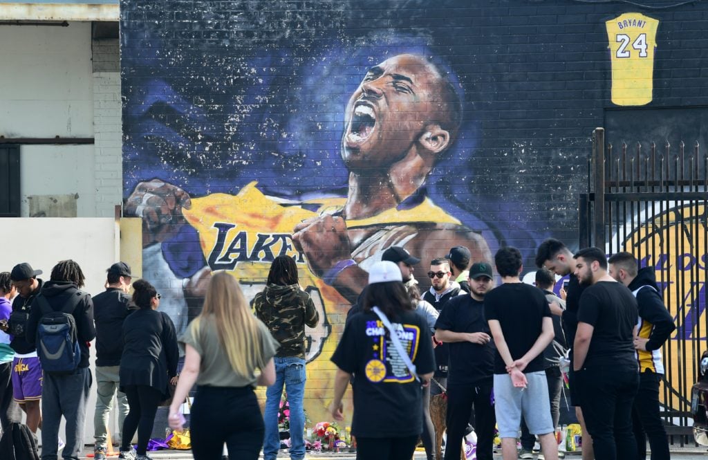Fans gather to mourn the death of NBA legend Kobe Bryant at a mural by Jonas Never near Staples Center in Los Angeles, California on January 27, 2020, a day after nine people were killed in the helicopter crash which claimed the life of the former Los Angeles Lakers star and his 13-year-old daughter, Gianna Bryant. Photo by Frederic J. Brown/AFP/Getty Images.