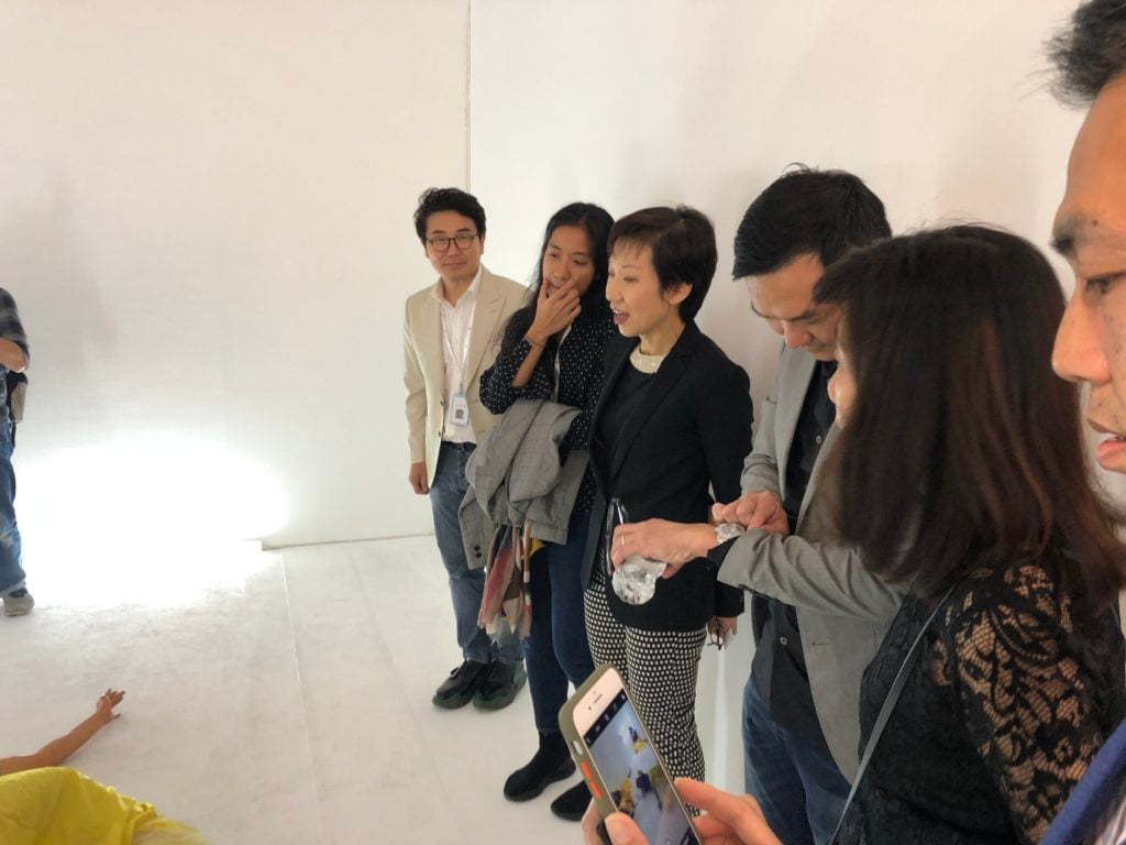 Grace Fu, Minister for Culture, Community and Youth (center), was engaged in a conversation with artist Eisa Jocson (second from left) discussing her work at the booth of The Columns Gallery booth at S.E.A. Focus. Photo: Vivienne Chow