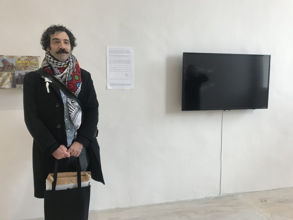 Michael Rakowitz in front of his video installation RETURN (2004–) at MoMA PS1. Courtesy of the artist. Photo: Jillian Steinhauer.