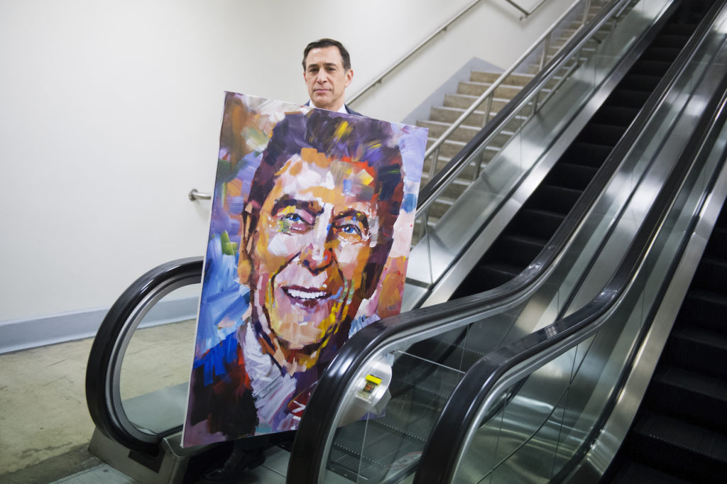 Representative Darrell Issa walks through the basement of the Capitol with a painting of Ronald Reagan by artist Steve Penley, February 11, 2015. Photo By Tom Williams/CQ Roll Call, via Getty Images.