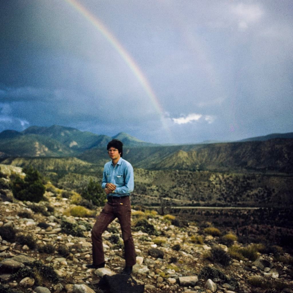 Nancy Holt, Robert Smithson with Rainbow, August 1971 at Arches National Park, Utah. © Holt/Smithson Foundation, licensed by VAGA at ARS, New York.