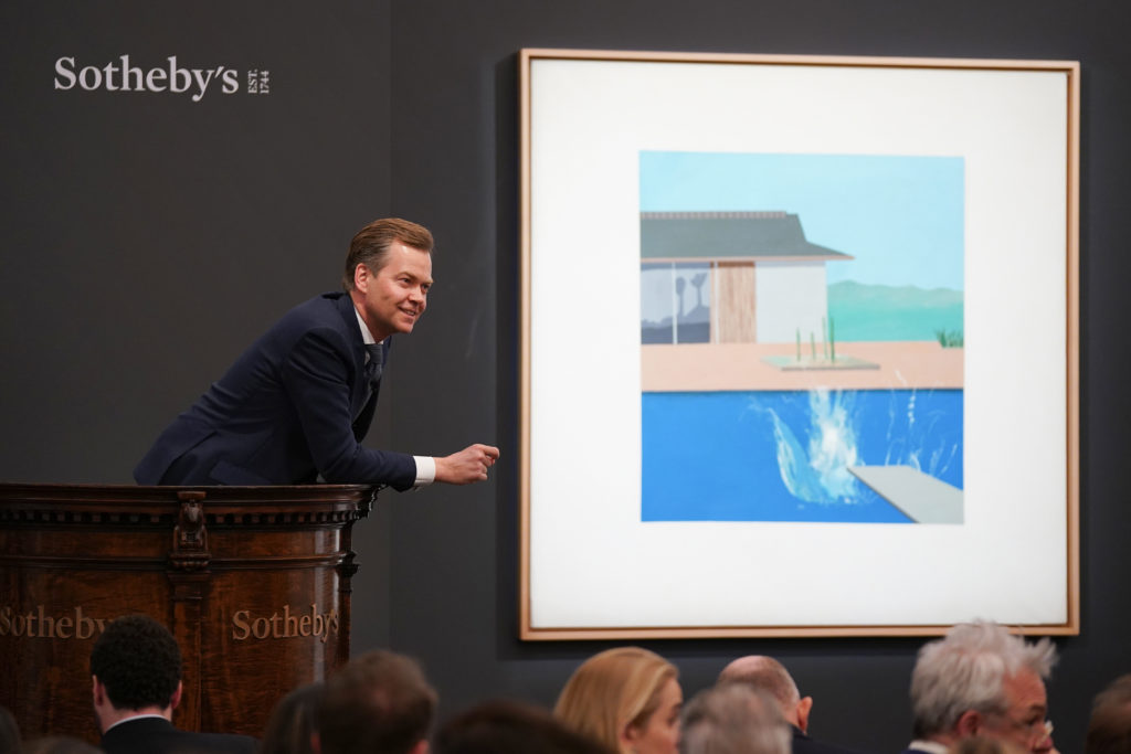 After only two bids, Sotheby's auctioneer Oliver Barker sold David Hockney's The Splash (1966) to a Sotheby's Los Angeles specialist for £23.1 million ($30 million). Photo by Michael Bowles/Getty Images for Sotheby's.