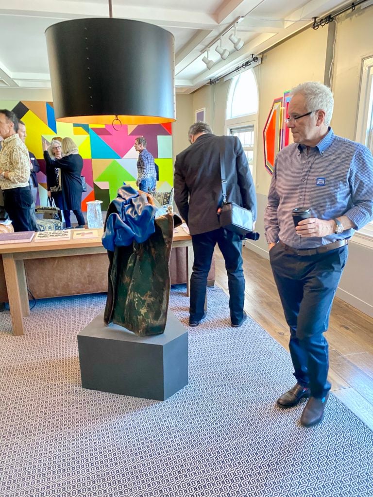 Collector and producer David Hoberman contemplates Kennedy Yanko's sculpture <i>Anoint</i> (2019) inside Kavi Gupta's booth at Felix 2020. Photography by Tim Schneider.