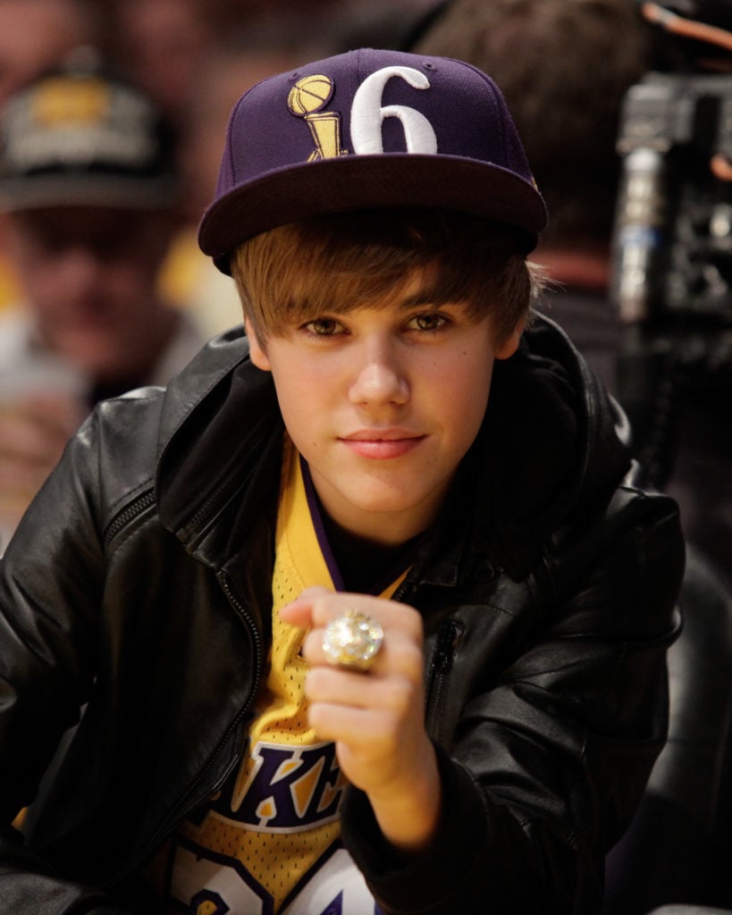 Justin Bieber longtime Lakers fan, showing off his team bling back in 2010. (Photo by Noel Vasquez/Getty Images)
