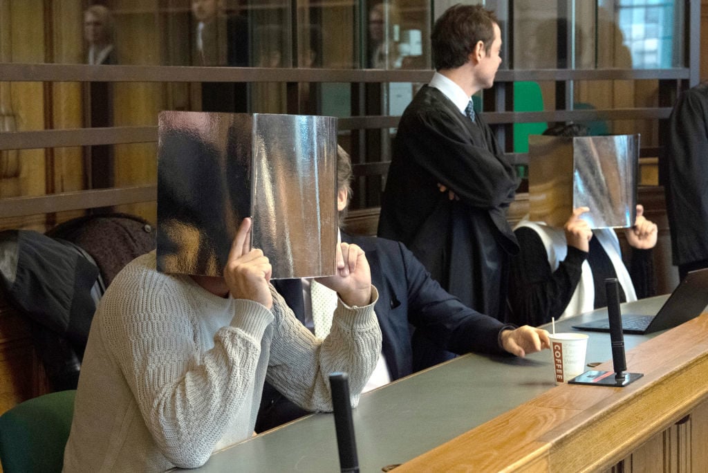 Two of the defendants sit next to their lawyers in the courtroom and cover their faces on February 20, 2020 in Berlin. Photo: Paul Zinken/dpa via Getty Images.