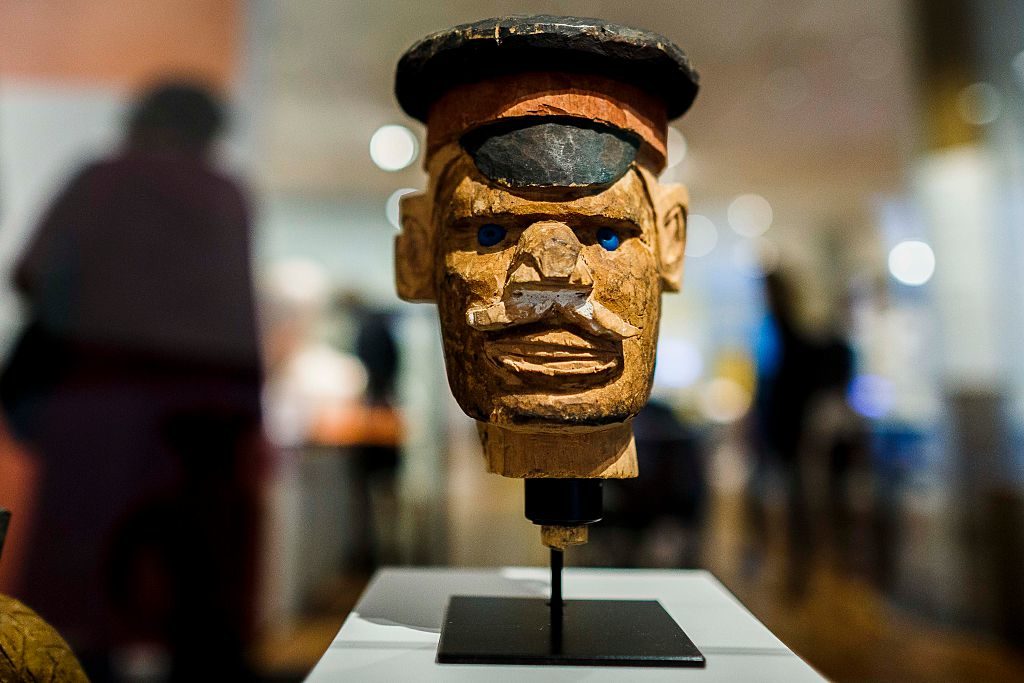 A wooden figure from the colonial period during a press preview of the exhibition 