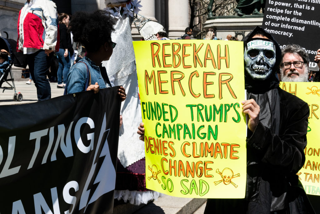 Demonstrators holding placards and banners during a protest against Rebekah Mercer being a member of the board of trustees of the American Museum of Natural History held in front of the museum in New York in 2018. Photo by Michael Brochstein/SOPA Images/LightRocket/Getty Images.