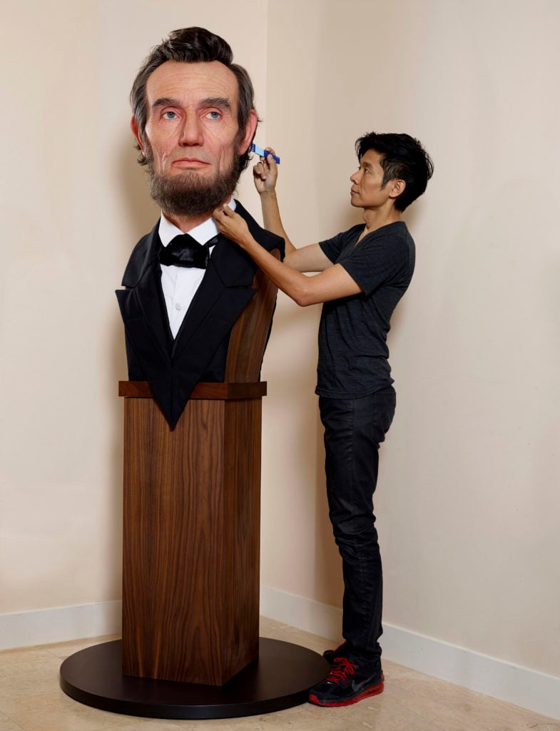Kazu Hiro with one of his sculptures, of Abraham Lincoln, that was on view at the LA Art Show with Santa Monica's CoproGallery. Photo courtesy of the artist. 
