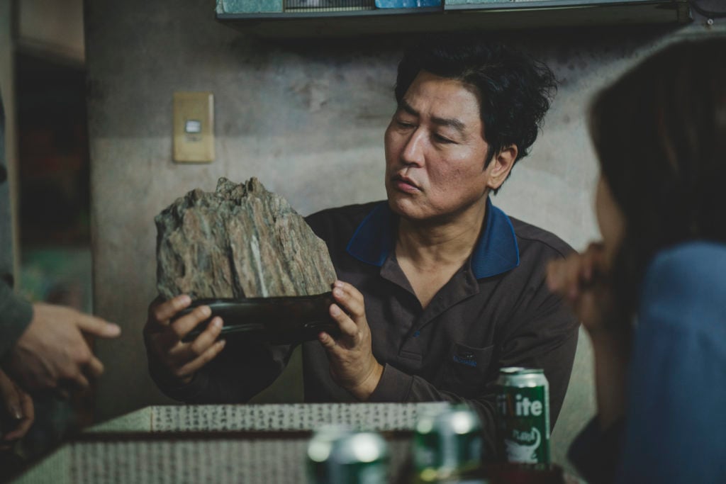 Song Kang-ho, who plays the destitute Mr. Kim, holding the suseok in Parasite. Photo ©2019 CJ ENM CORPORATION, BARUNSON E&A ALL RIGHTS RESERVED